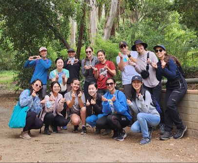 Members from the Li and Fregoso Labs making heart symbols with their hands after a hike